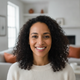 Portrait of a happy woman in her 30s smiling, conveying satisfaction and trust.